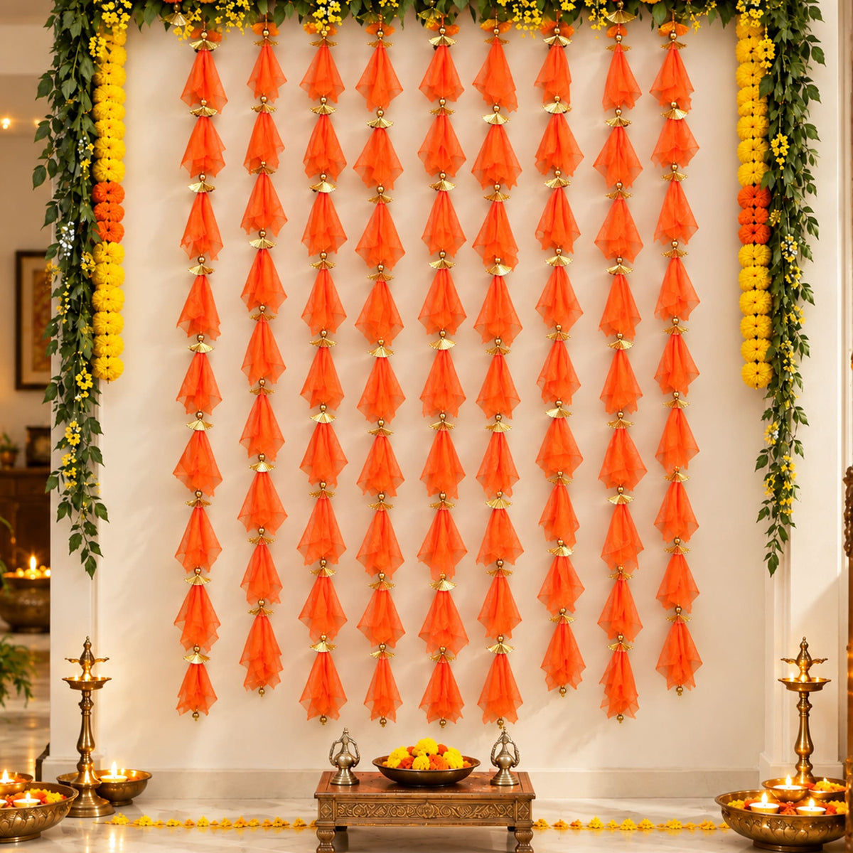 Orange sheer fabric tassels with gold metallic connectors in gotta patti net backdrop for diwali eid and wedding decor
