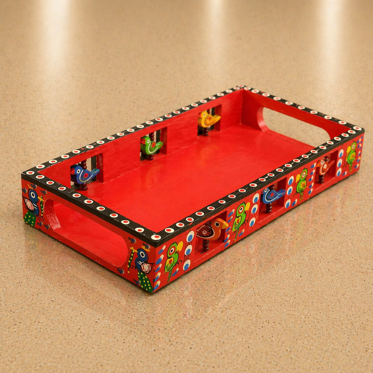 Vibrant red wooden serving tray with hand painted colorful bird motifs and black trimmed edges with white dots