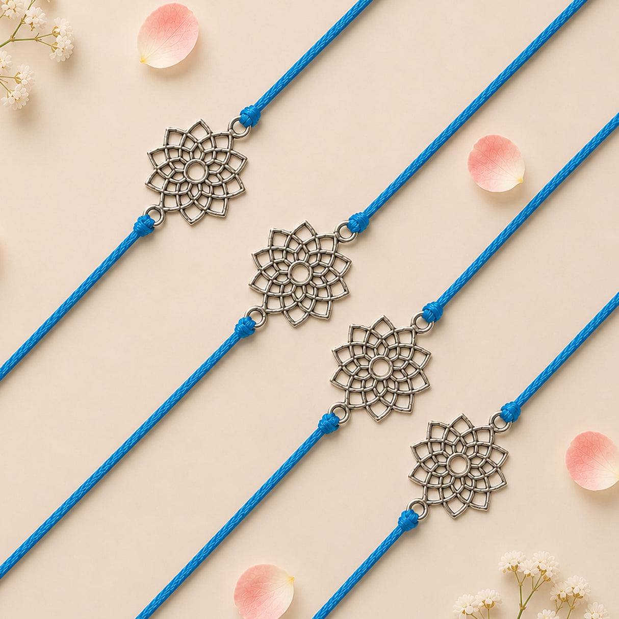 Blue cord designer lotus charm rakhi with intricate silver-toned floral charms for raksha bandhan protection gift