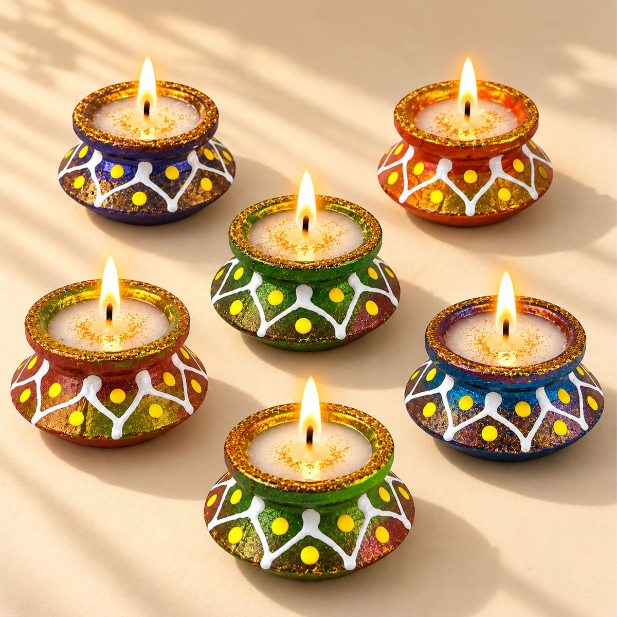 Handmade colorful clay matki diya with glittery gold rims white patterns and yellow dots for diwali pooja and décor