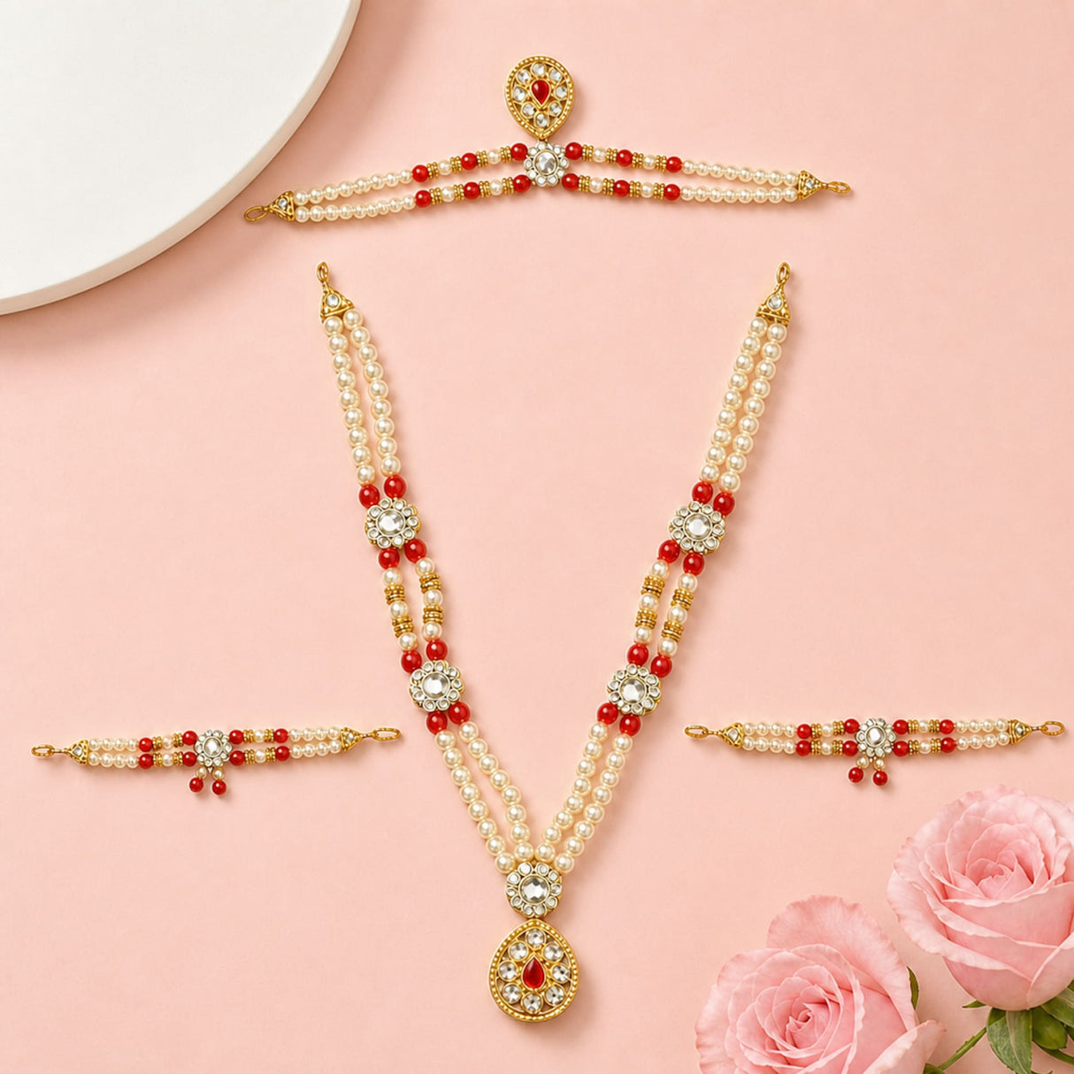 Gold-toned Hindu God Goddess shringaar jewelry set with intricate red and white pearl strands and sparkling gemstone accents