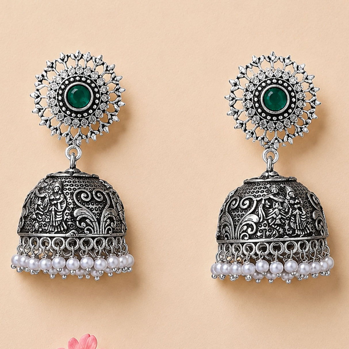 Boho oxidized silver tone jhumka earrings with intricate filigree, green gemstone, clear stones, and pearl dangles for ethnic wear