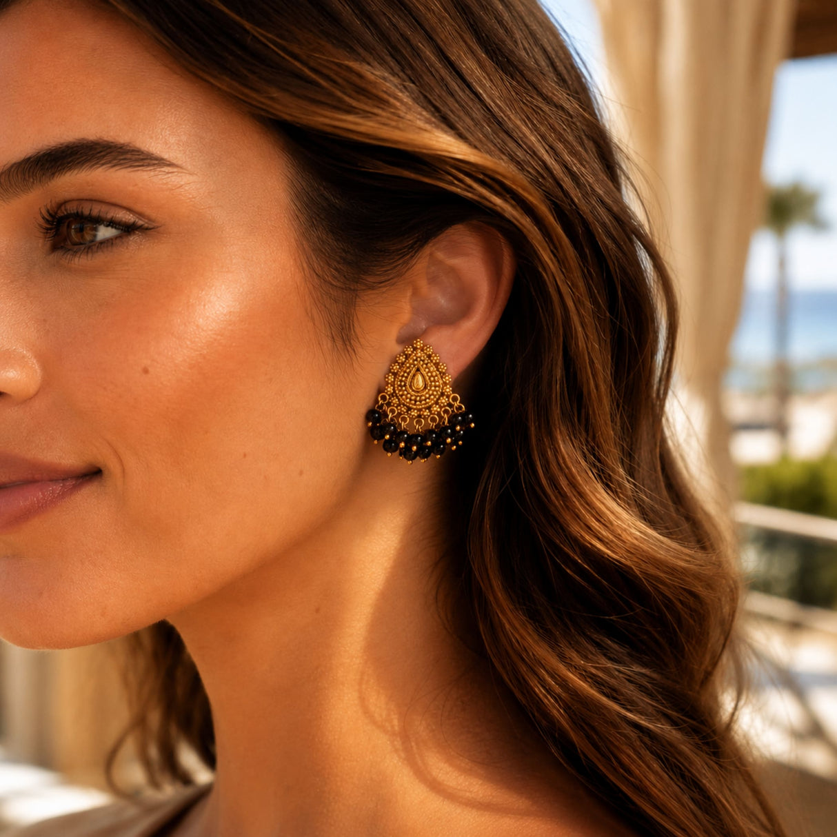 Indian chandbali earrings with gold tone filigree teardrop and black bead fringe for wedding and ethnic wear
