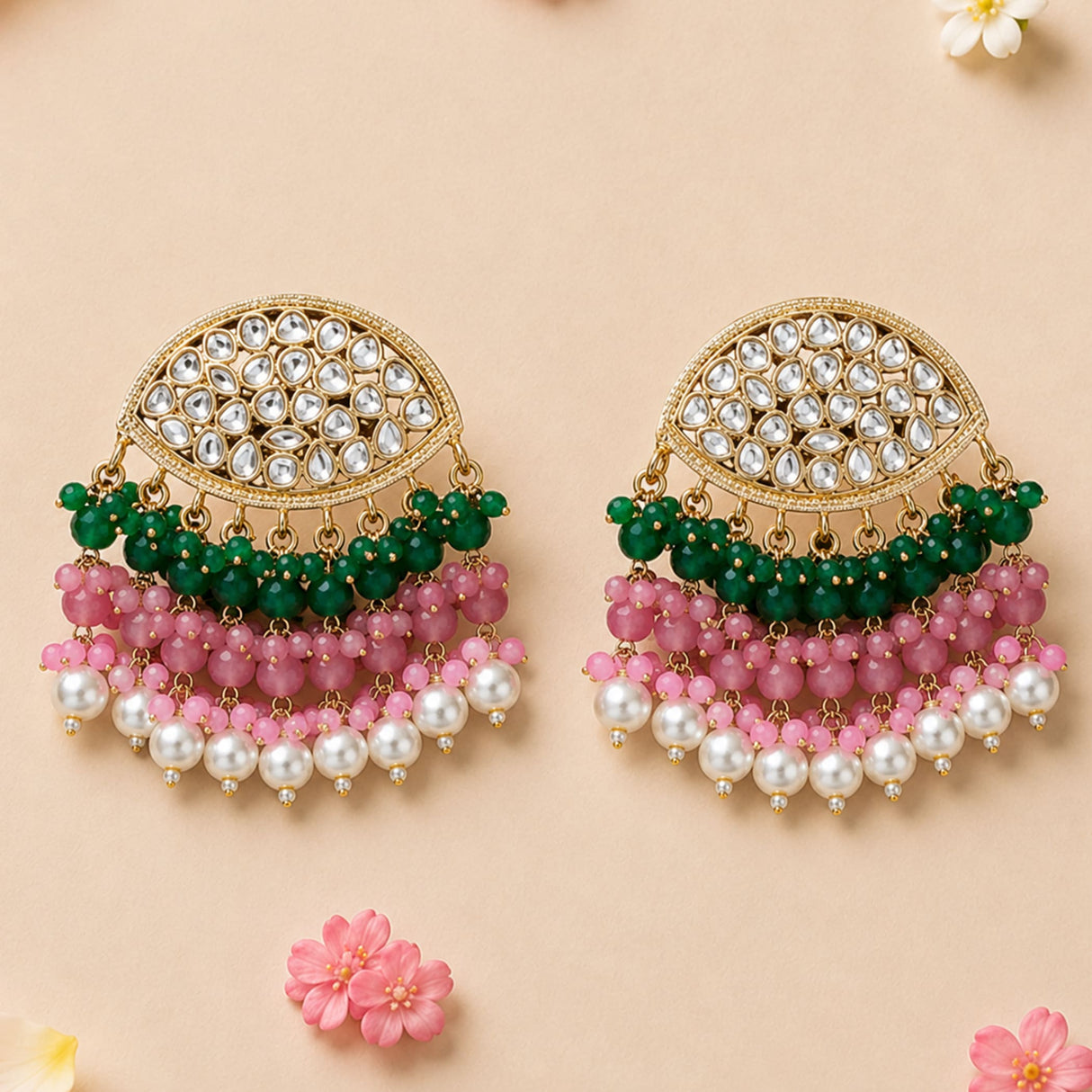 Elegant gold tone Indian kundan stone earrings featuring clear crystals, green and pink beads, and white pearls for ethnic wear
