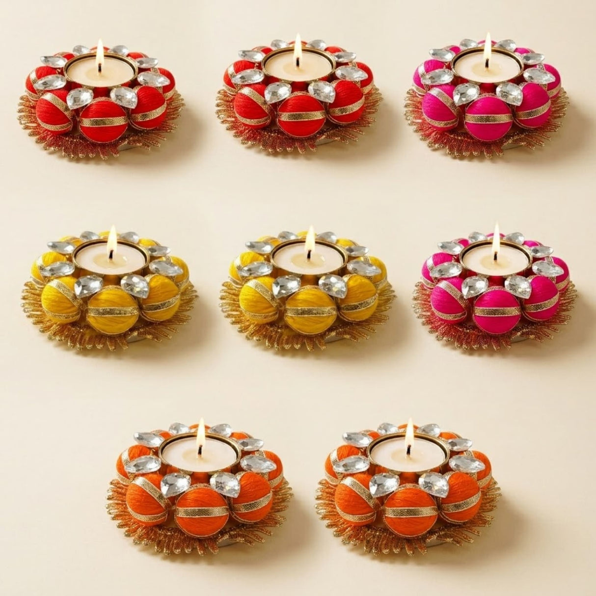 Vibrant handcrafted tea light candle holders in red yellow and orange with gold trim and crystal accents for home decor