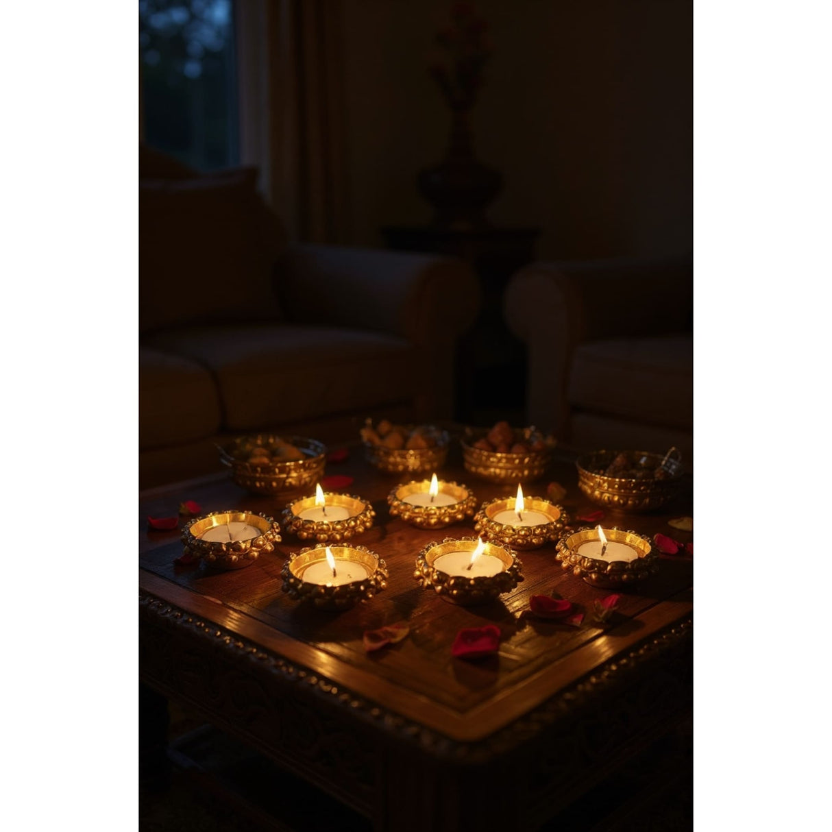 Lit golden Indian tealight candle holders with decorative edges on a dark table for festive decor
