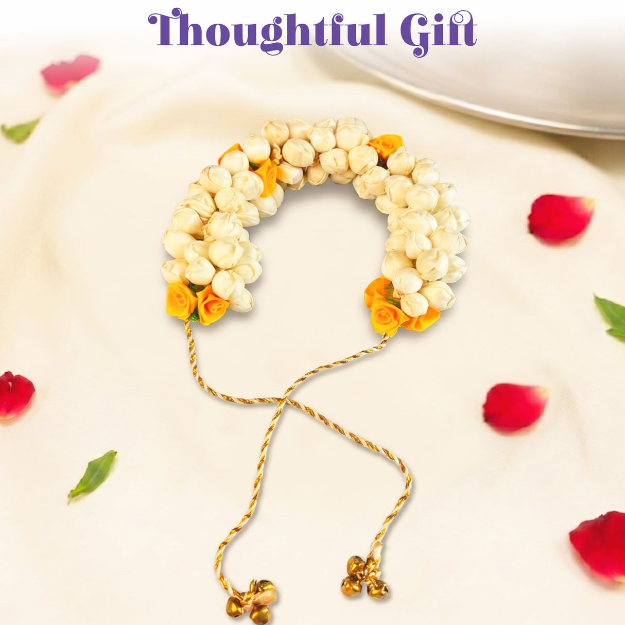 Traditional artificial jasmine gajra with white and yellow flowers, gold-toned twisted cord, and bell charms for bridal hair