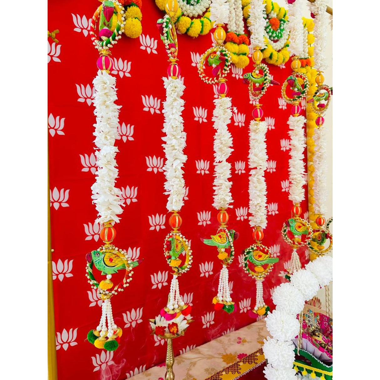 Decorative white flower garlands with colorful bird and lotus hangings for Indian wedding decor