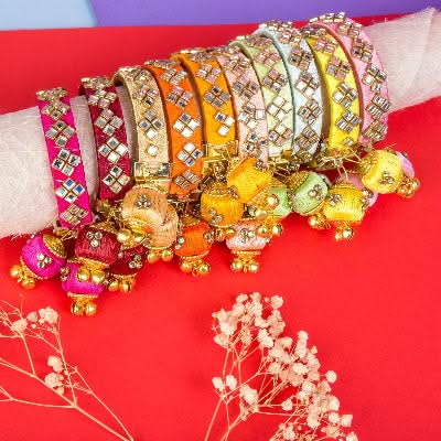 Colorful jeweled bangles with dangling tassels for Karva Chauth and Hindu Pooja celebrations