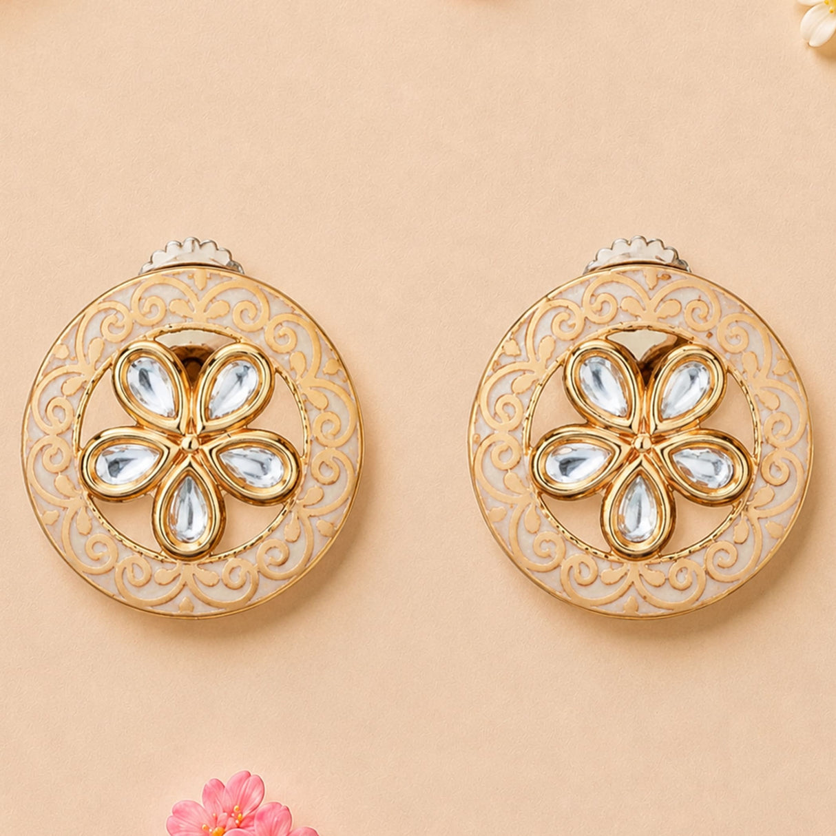 Indian kundan stud earrings for women in gold tone with intricate filigree and teardrop clear stones floral design