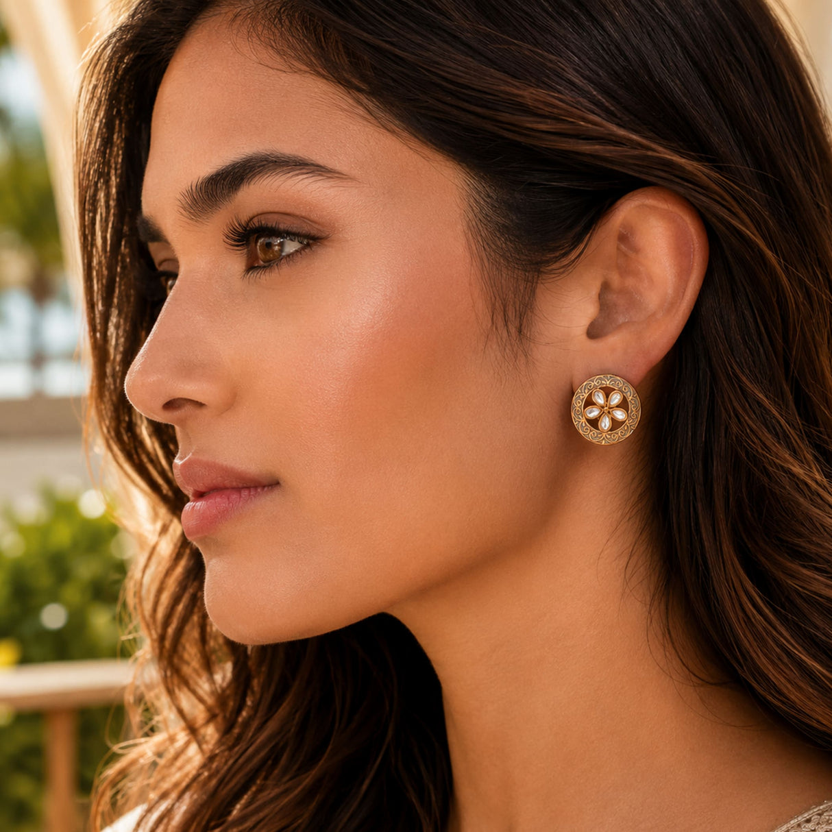 Indian kundan gold-toned circular stud earring with intricate floral design and central gemstone for bridal wear