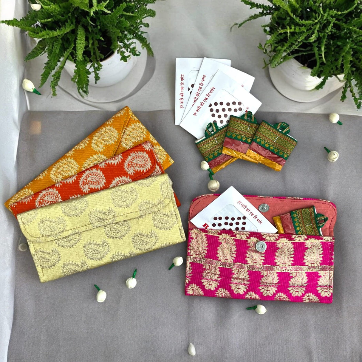 Colorful patterned fabric wallets in a traditional gift hamper for Navratri and festive occasions