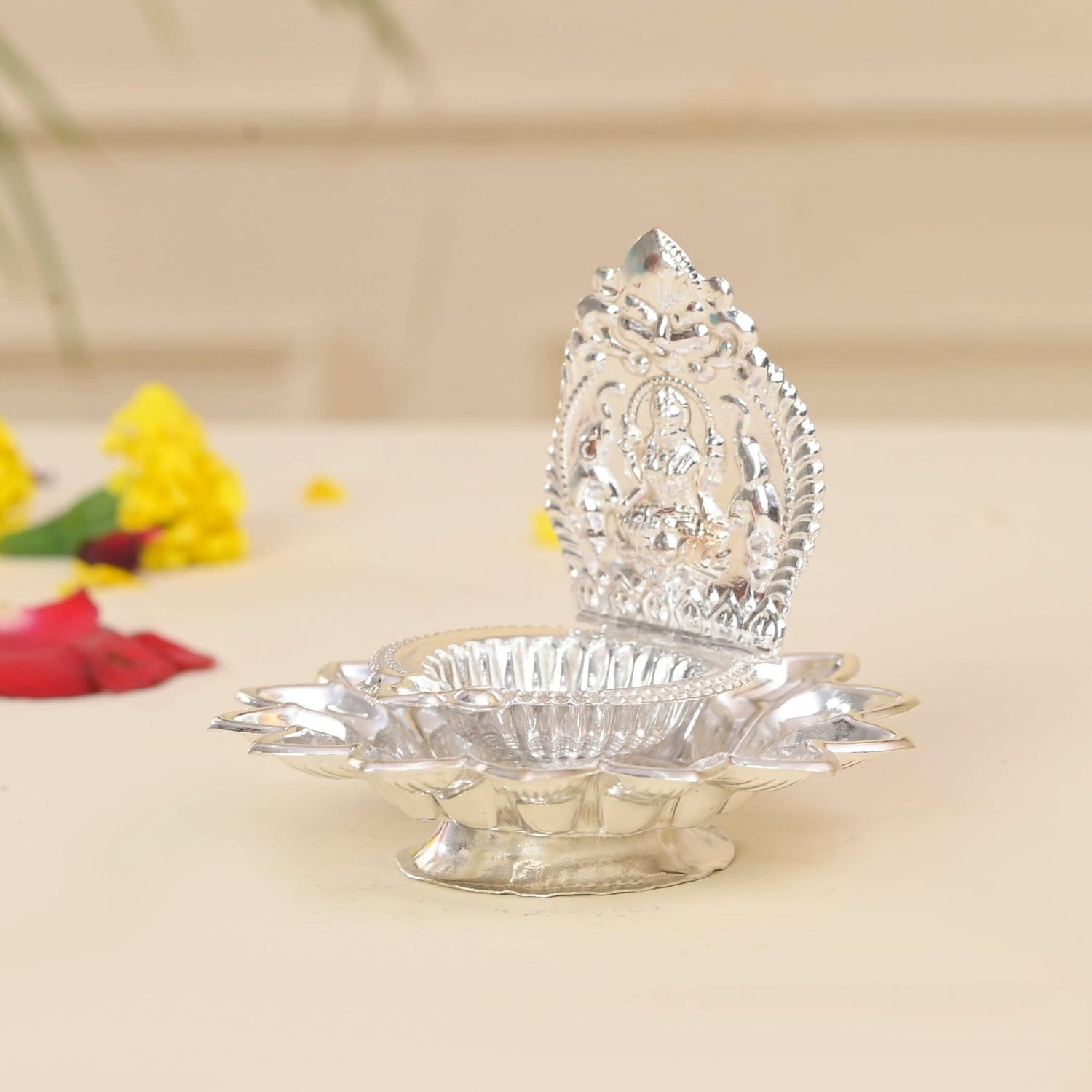 Silver-colored ornate oil lamp for Hindu Pooja and Diwali celebrations