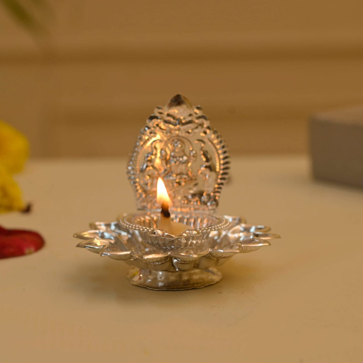 Silver diya with lit wick for Diwali decoration and Hindu religious ceremonies