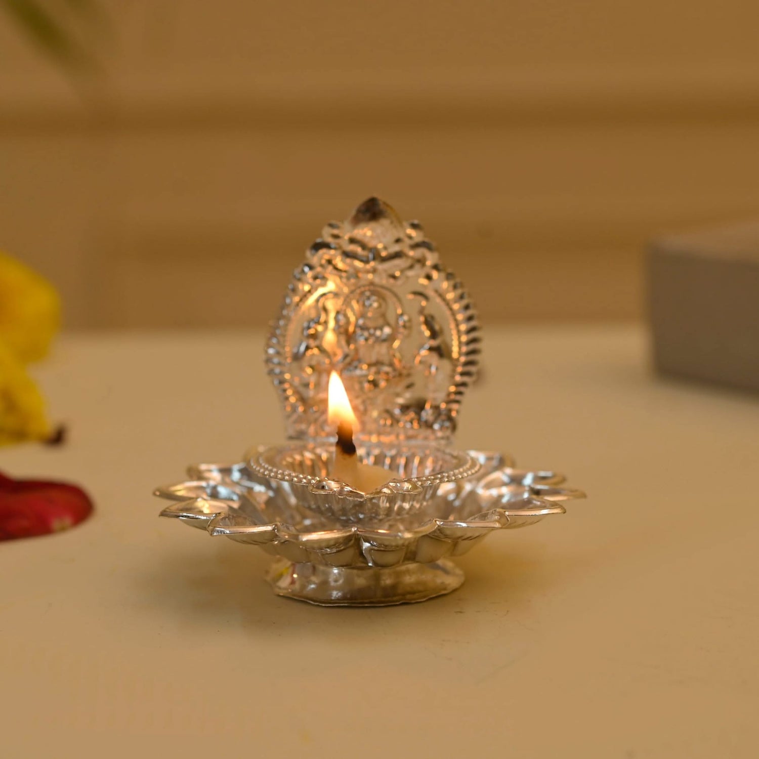Silver diya with lit wick for Diwali decoration and Hindu religious ceremonies