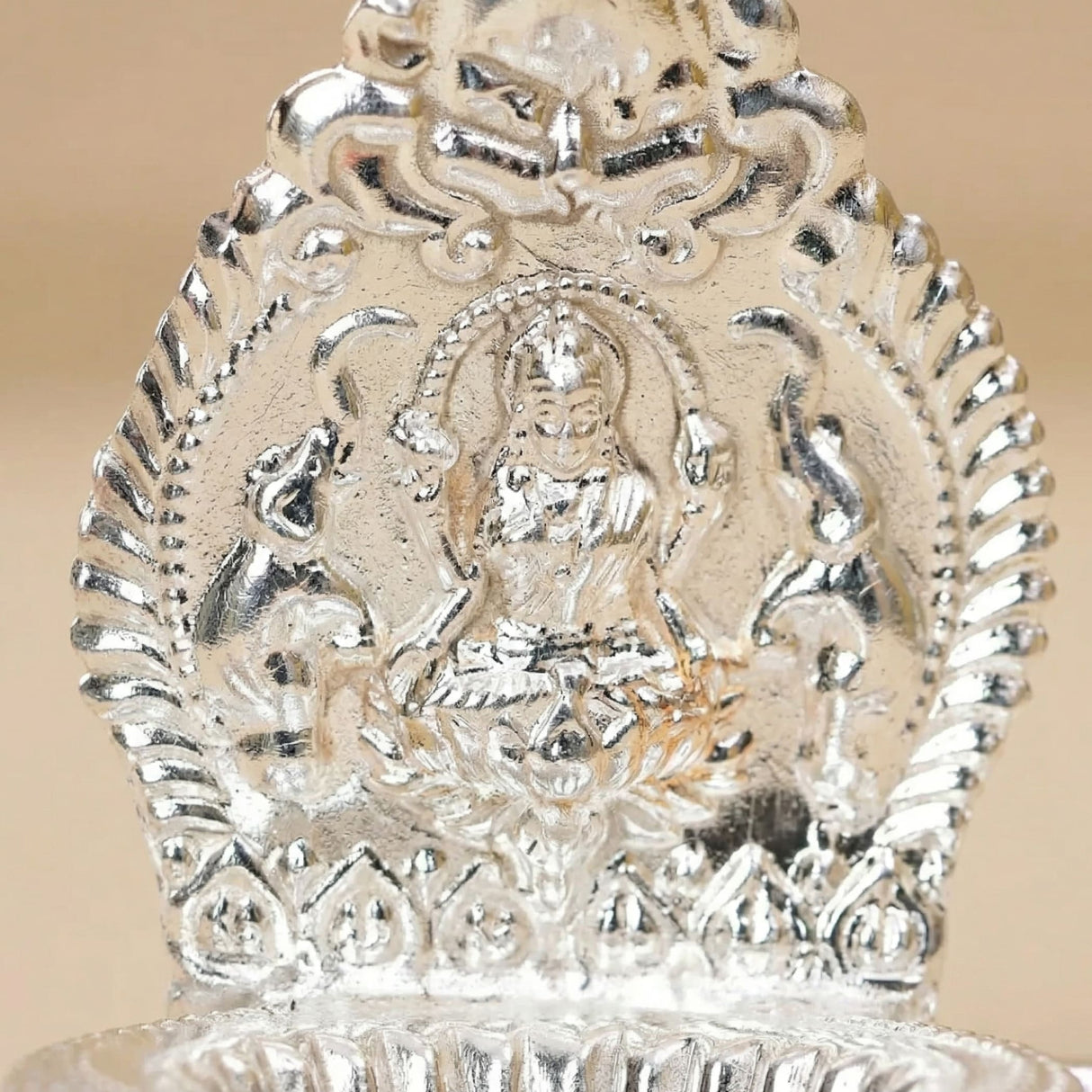 Lakshmi silver plated diya lamp with intricate embossed details and polished finish for diwali puja decoration