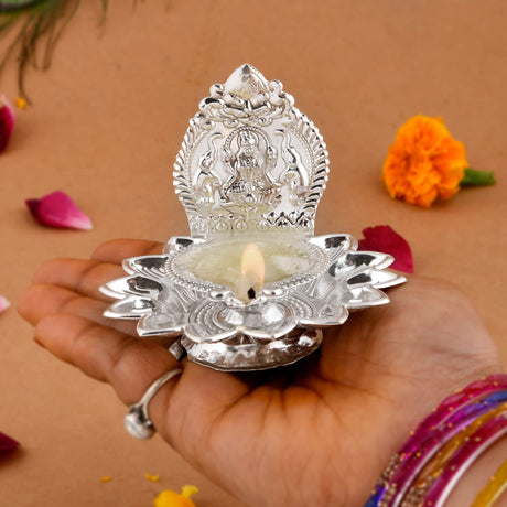 Silver lotus diya with deity for Diwali devotional and Hindu Puja decoration
