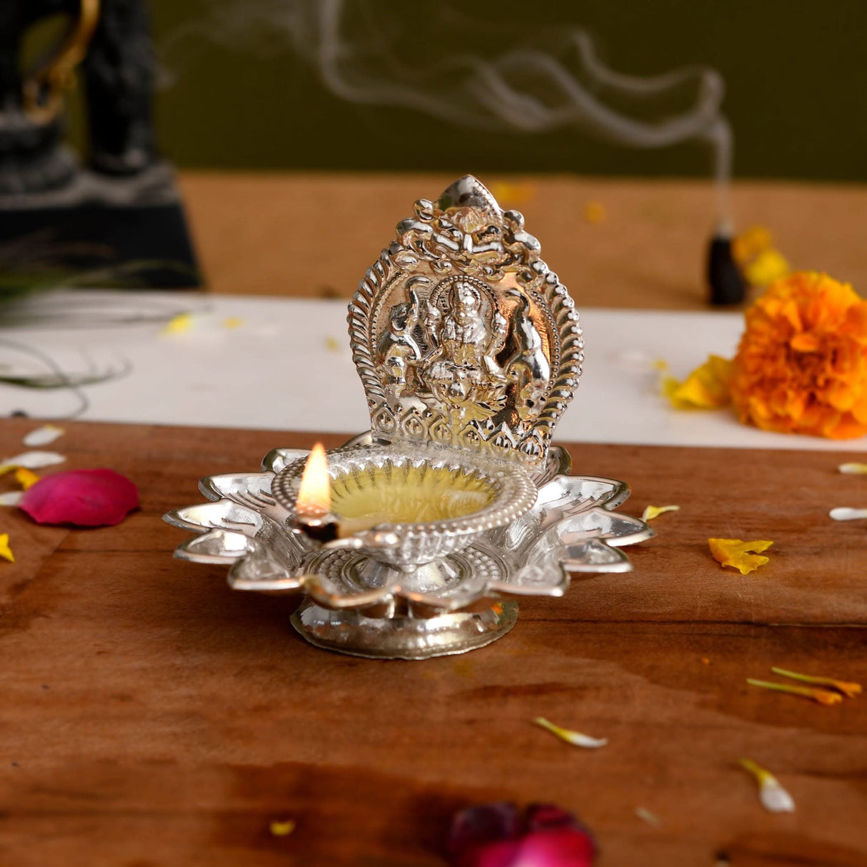 Silver oil lamp with deity for Diwali Puja and Hindu religious celebrations