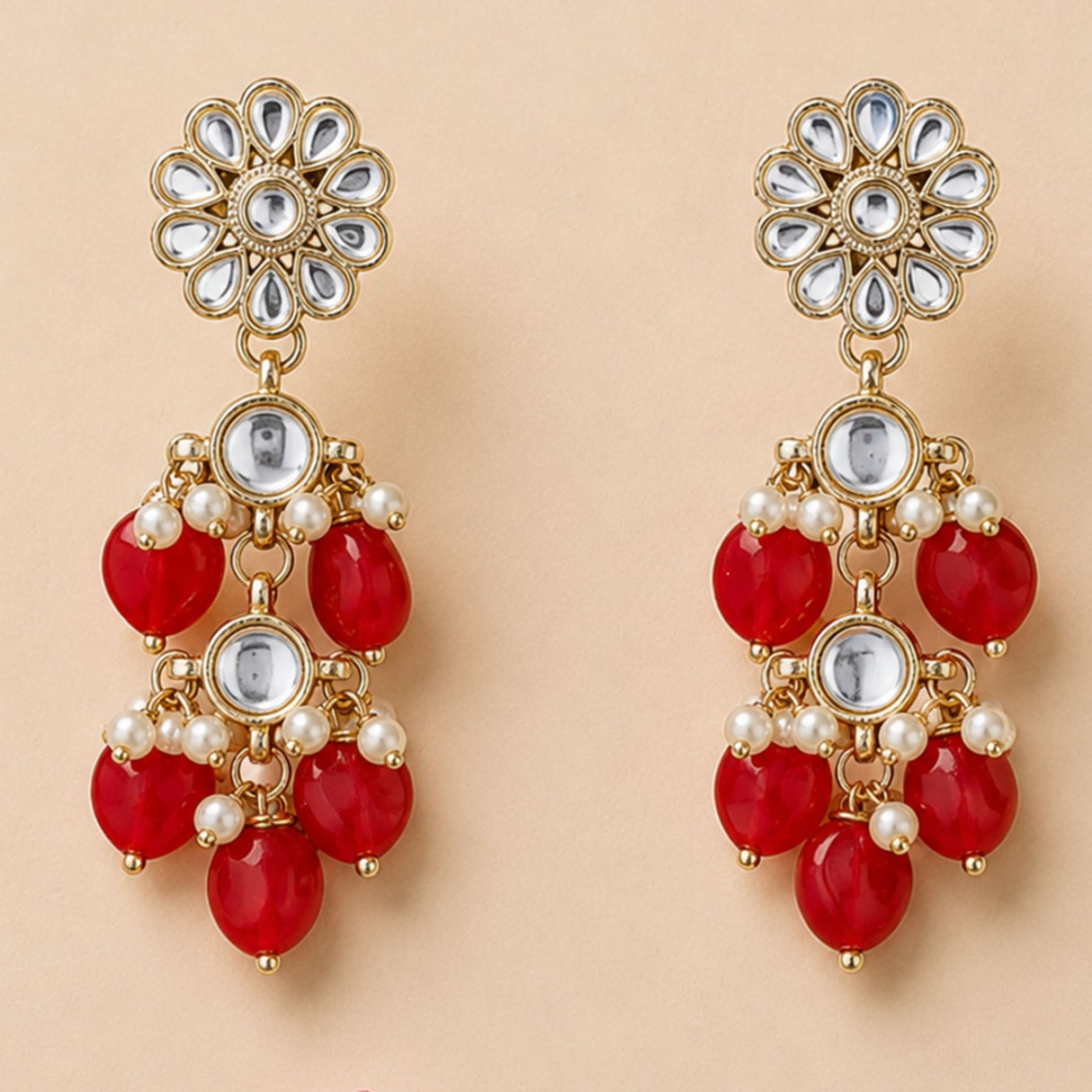 Gold tone indian floral kundan stone earrings with clear stones red gemstones and faux pearls for diwali wedding wear