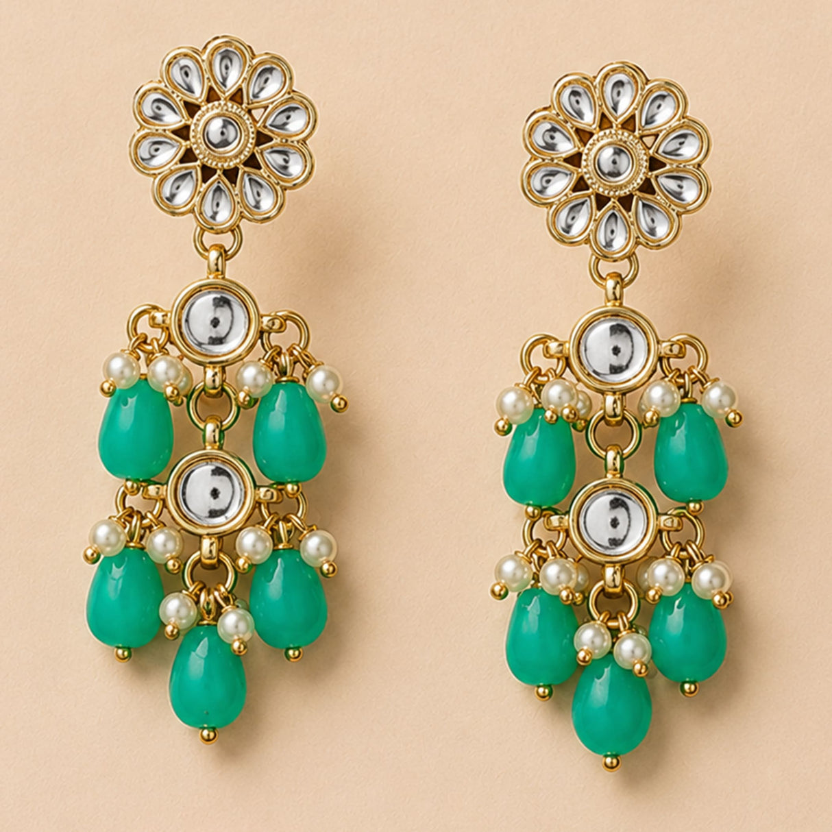 Elegant gold tone indian floral kundan stone earrings with silver mirror inlays emerald beads and faux pearl accents for ethnic wear