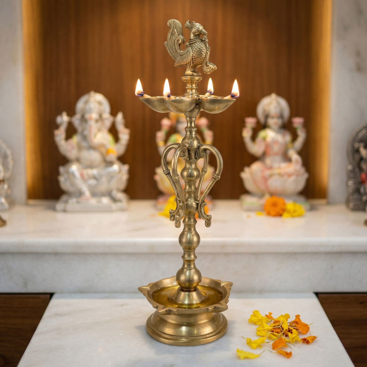 Large golden brass oil lamp with intricate carvings and rooster finial for diwali puja and home decor