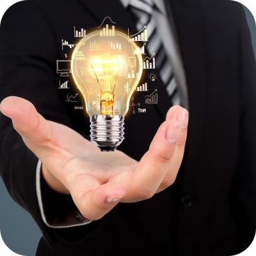 Glowing light bulb hovering above an open hand, surrounded by illuminated graphs and charts.