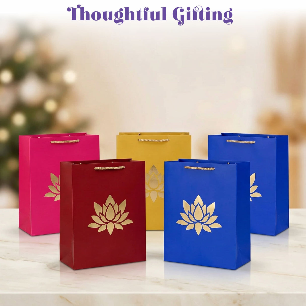 Vibrant lotus paper carry bags in pink red yellow and blue with gold lotus designs for indian wedding diwali gifts