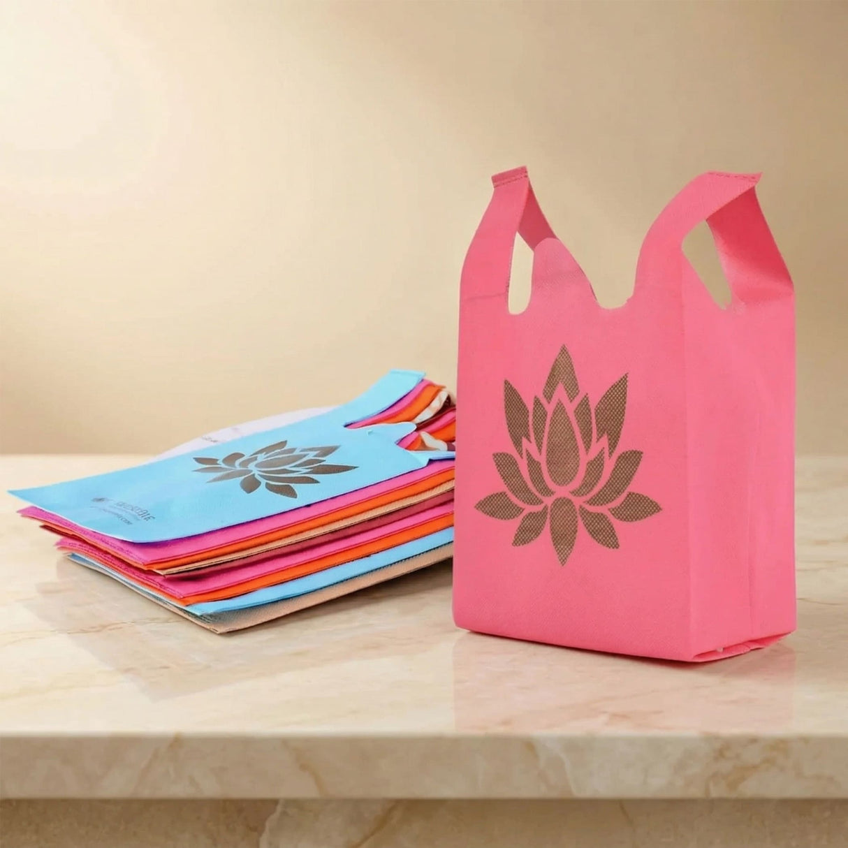 A vibrant pink non woven reusable shopping bag with a brown lotus flower print for Indian wedding and puja
