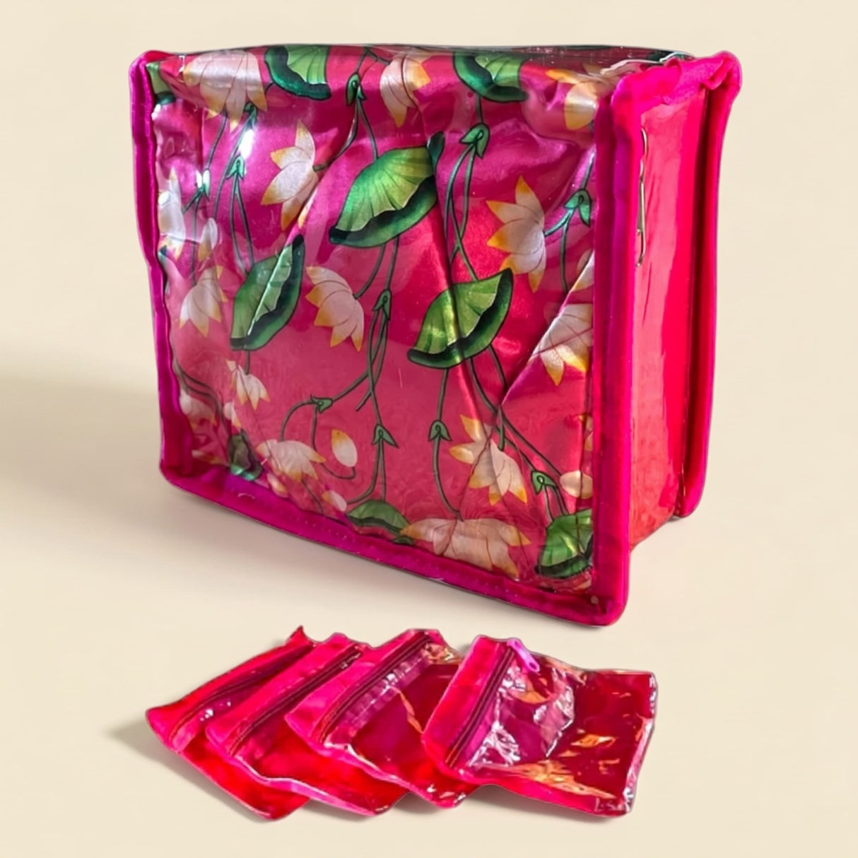 Vibrant pink lotus print satin indian jewelry box pouch with transparent zippered compartments for travel storage