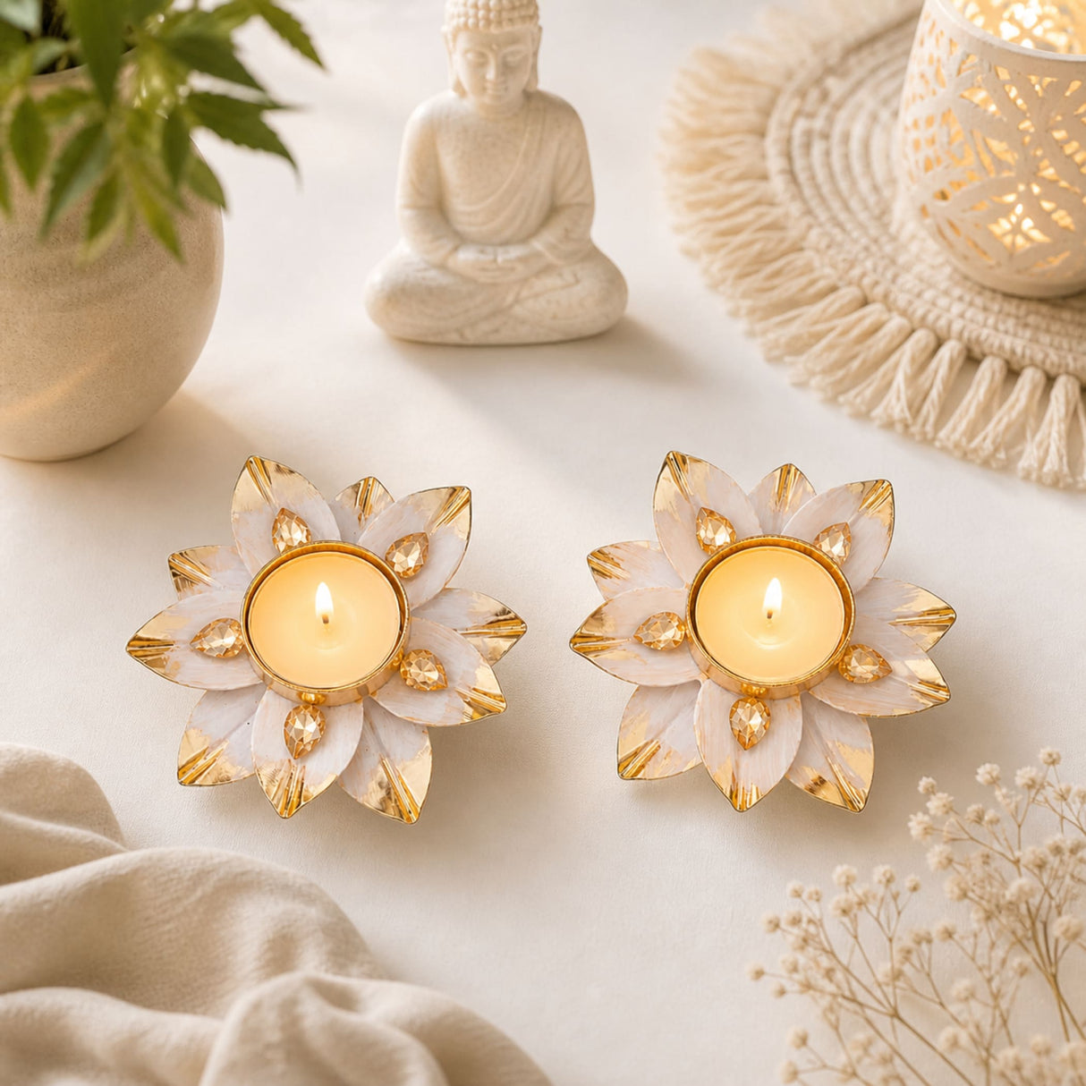 Two white and gold lotus-shaped tealight holders with faceted gemstone accents for decorative diya and festive use