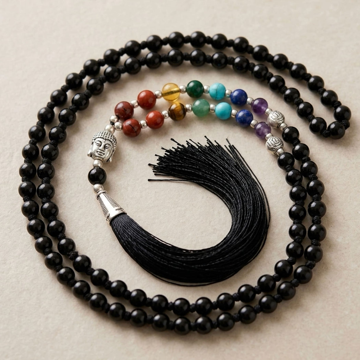 Black beaded LOVENSPIRE 108 mala necklace with silver buddha head pendant colorful chakra gemstones and black tassel