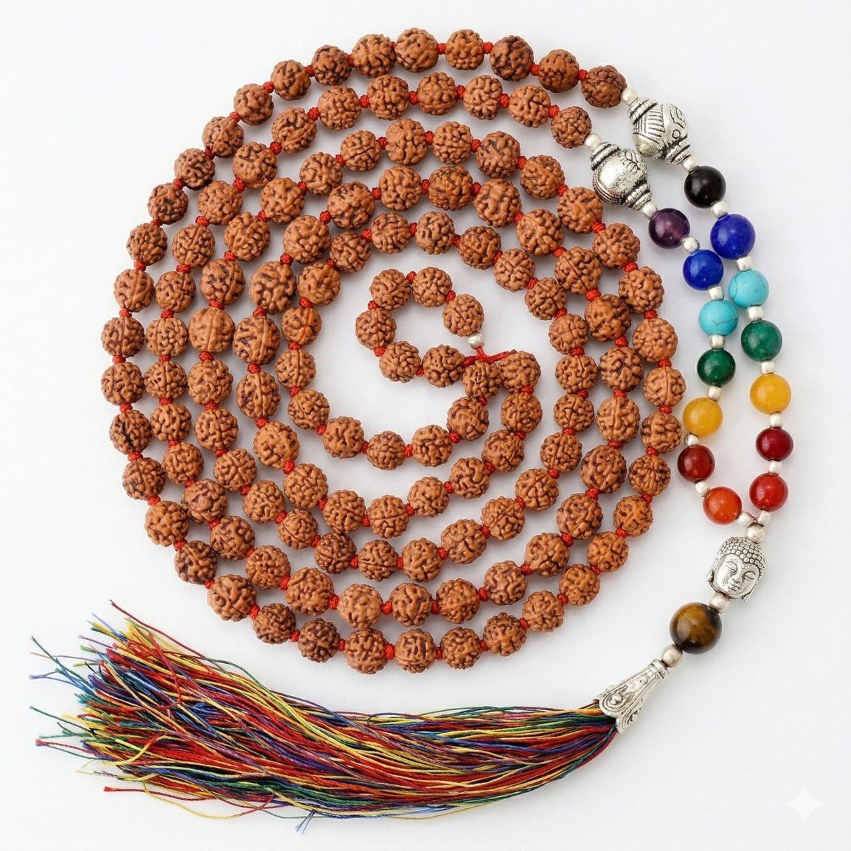 A coiled brown rudraksha mala necklace with silver buddha head bead colorful gemstones and multicolored tassel by LOVENSPIRE