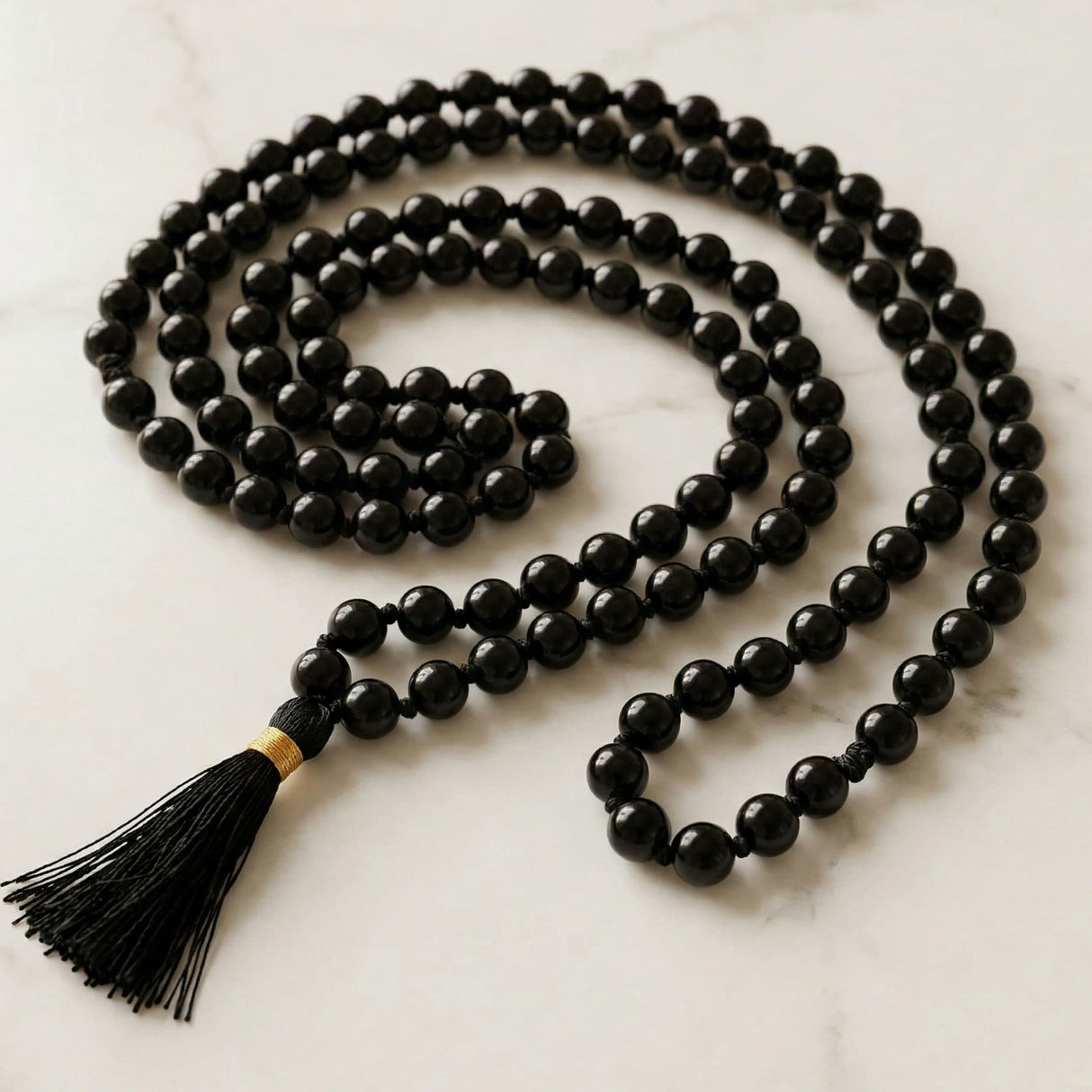 Lovenspire black beaded 108 mala necklace with gold accented tassel for yoga meditation and natural healing crystals