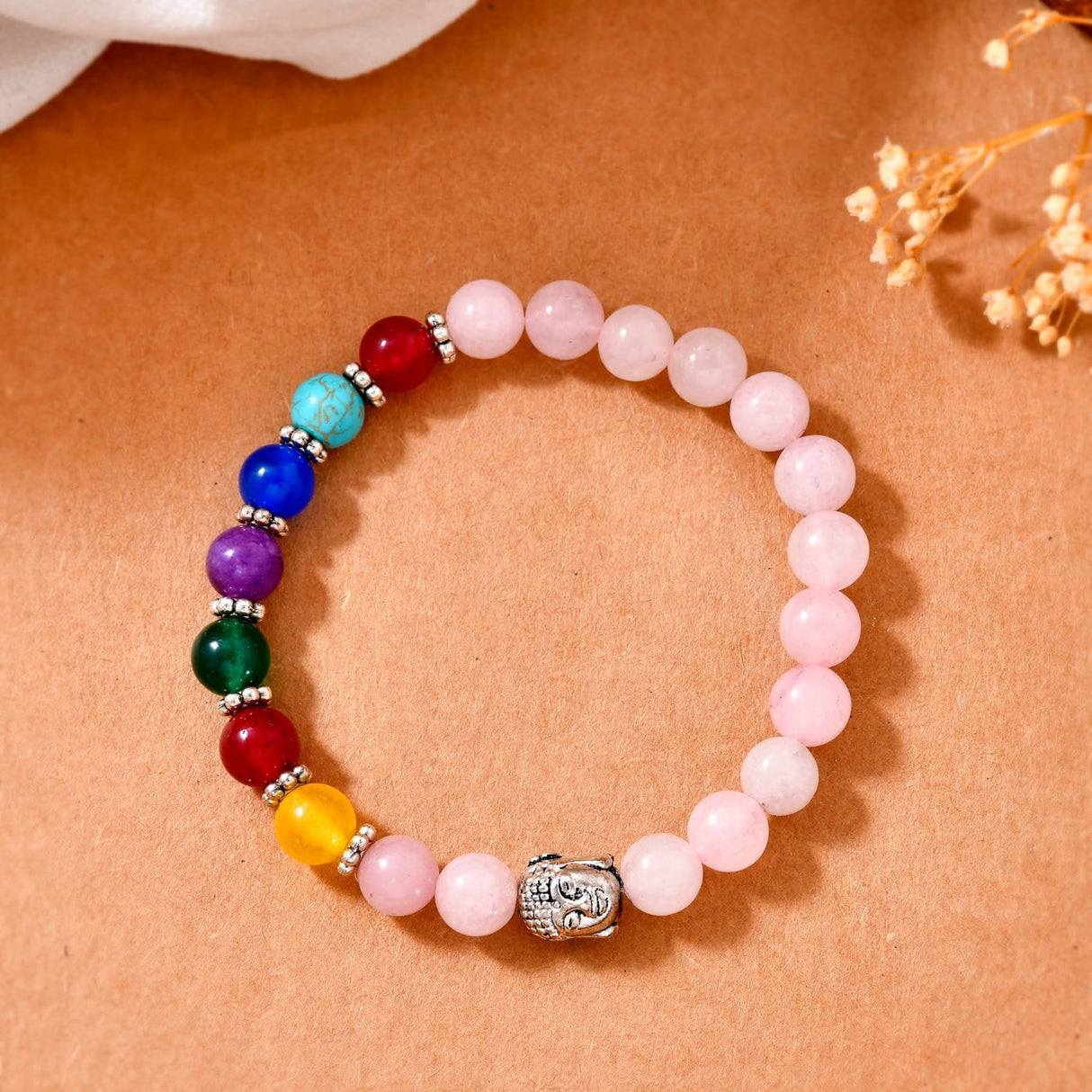 Colorful beaded bracelet featuring Rose Quartz crystals and Buddha head pendant for meditation