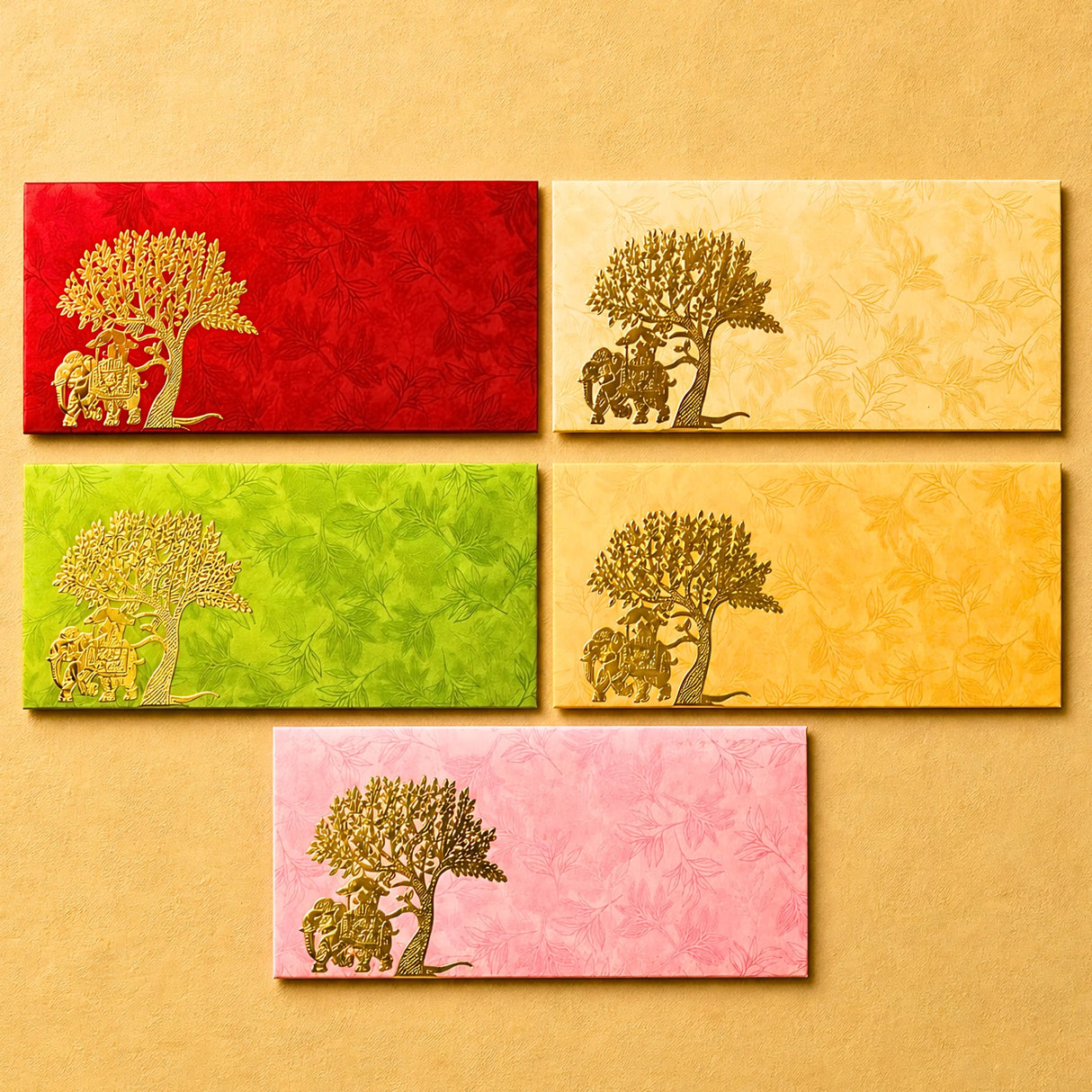 Set of five colorful textured money envelopes with gold embossed elephant and tree designs for Indian wedding gifts
