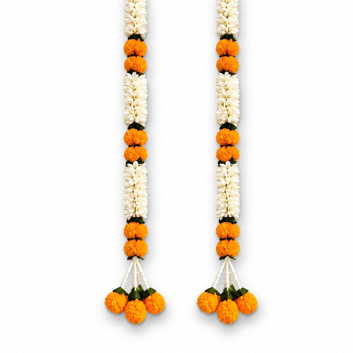 Two vibrant orange and white artificial marigold flower garlands with green leaves and decorative tassels for wedding decor