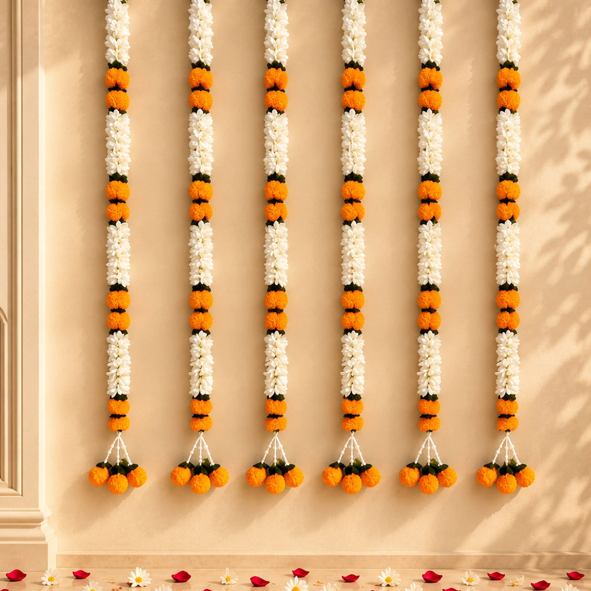 Artificial jasmine and marigold flower garlands with white and orange blossoms and green leaves for wedding and decor