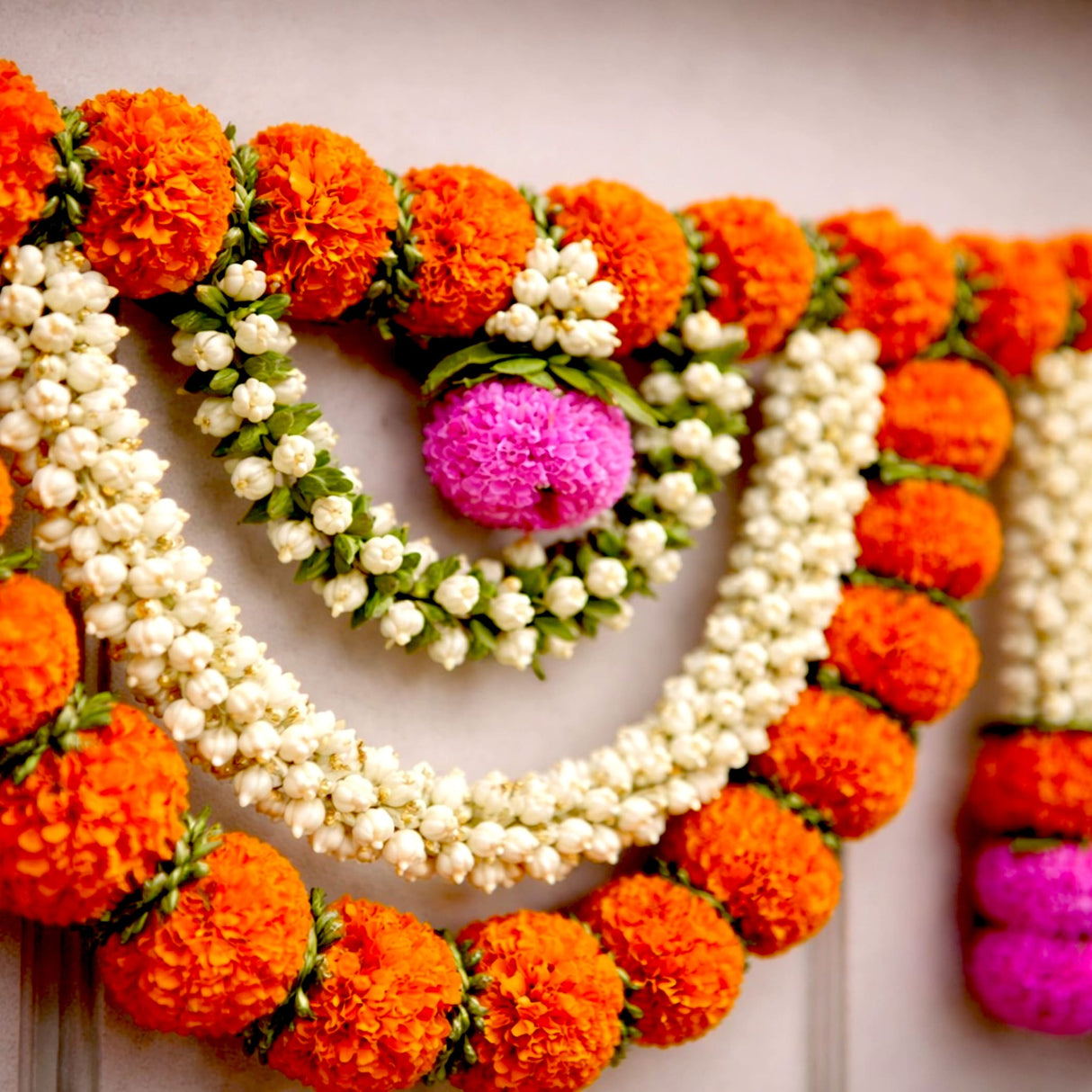 Vibrant orange white marigold jasmine garland toran with pink pom-pom, 44 inch Diwali decor