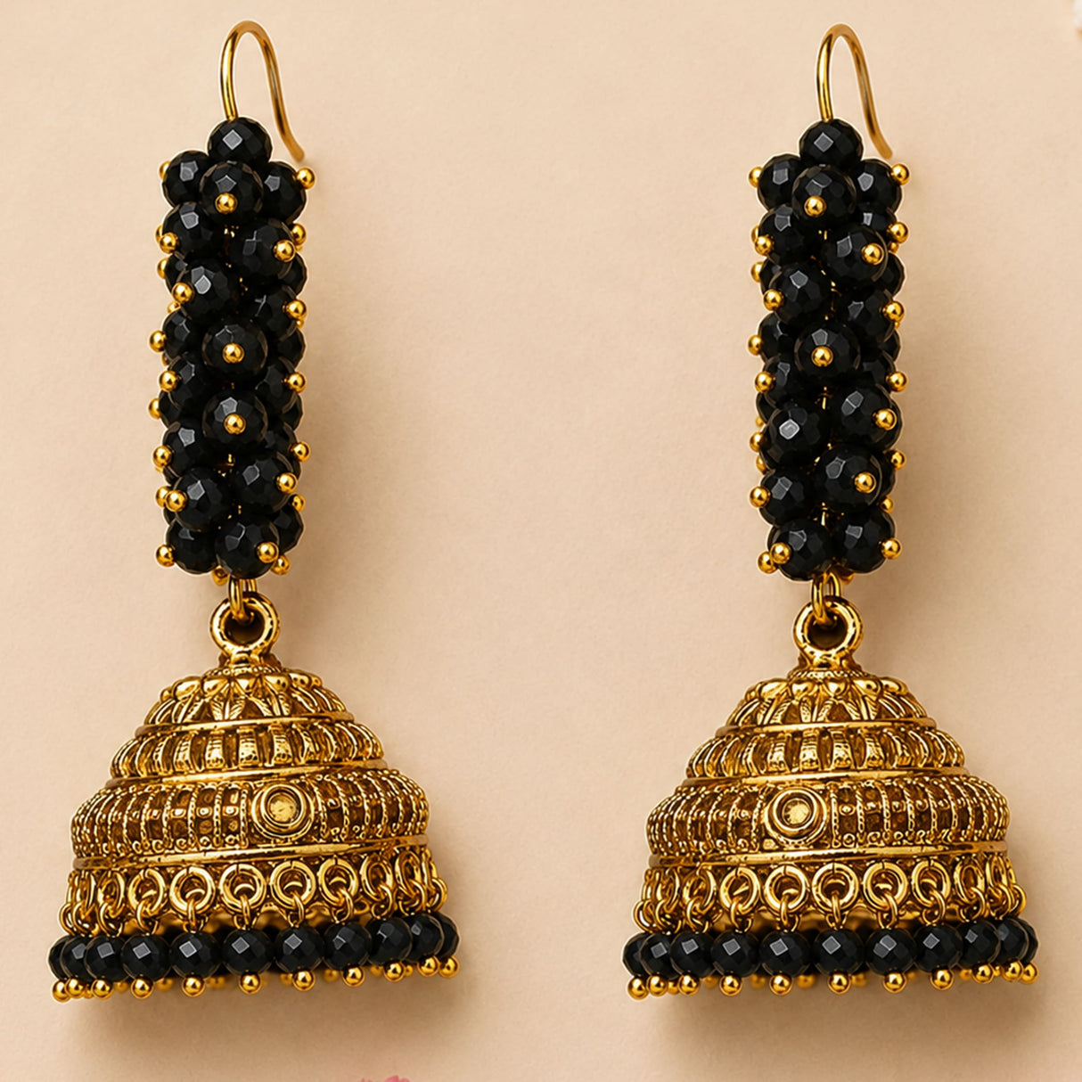 Elegant black and gold jhumka earrings with intricate filigree and faceted beads for traditional Diwali and wedding wear