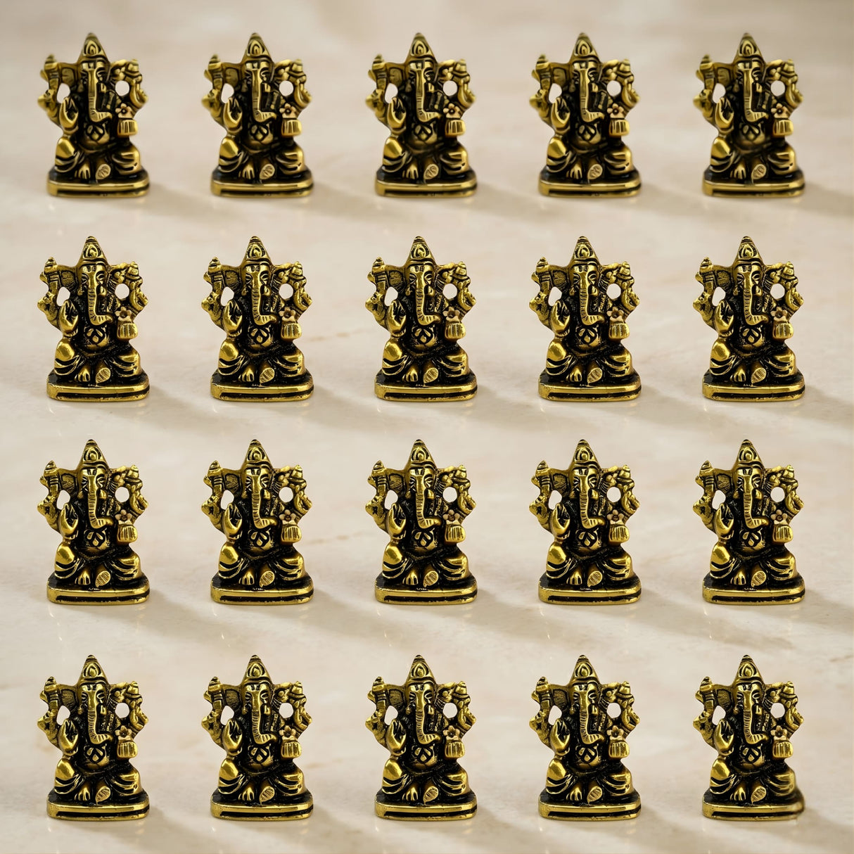 Metal ganesha idol made of golden brass with intricate detailing and polished finish for home temple and decor