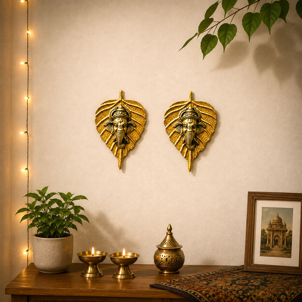 Golden metal leaf ganesha wall hanging decor with intricate ganesha head carvings for home and office interior decoration