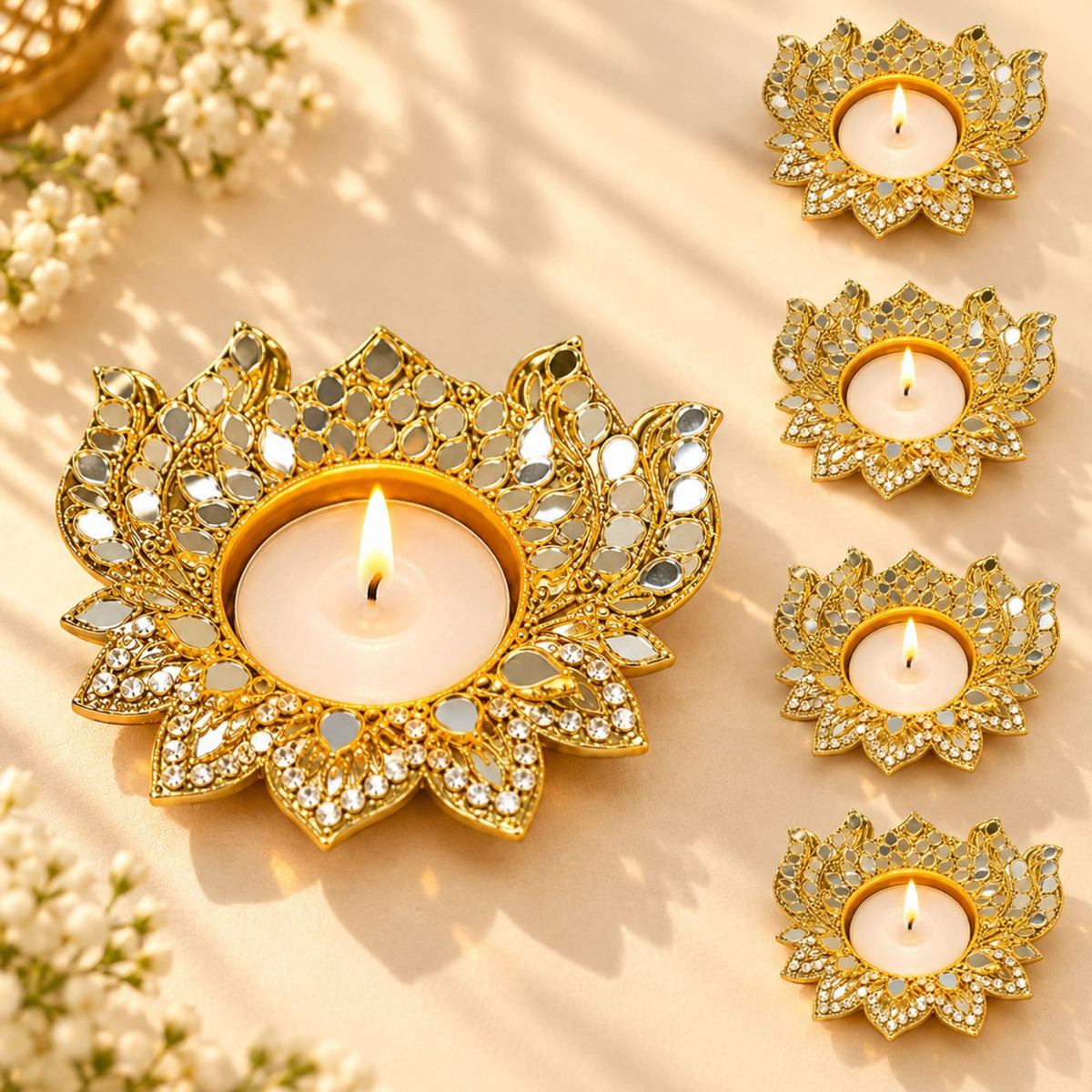 Gold lotus-shaped metal tea light candle holder with mirrored and crystal embellishments for festive home decor