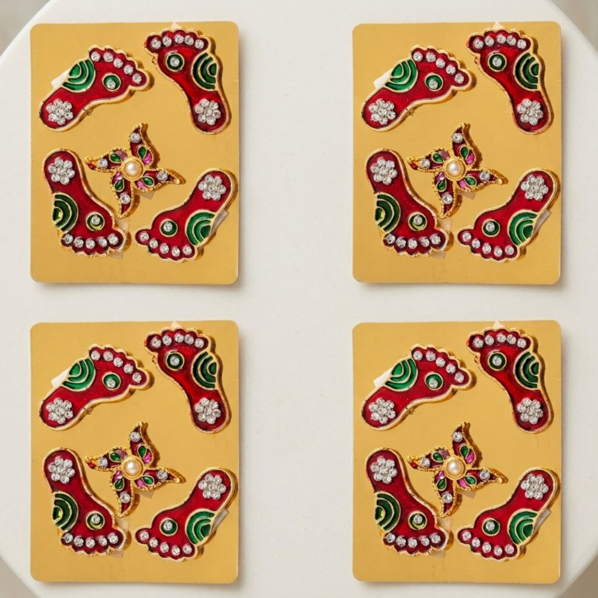 Metallic lakshmi charan paduka 2 pairs feet red and green with silver rhinestones on golden cards for diwali decoration