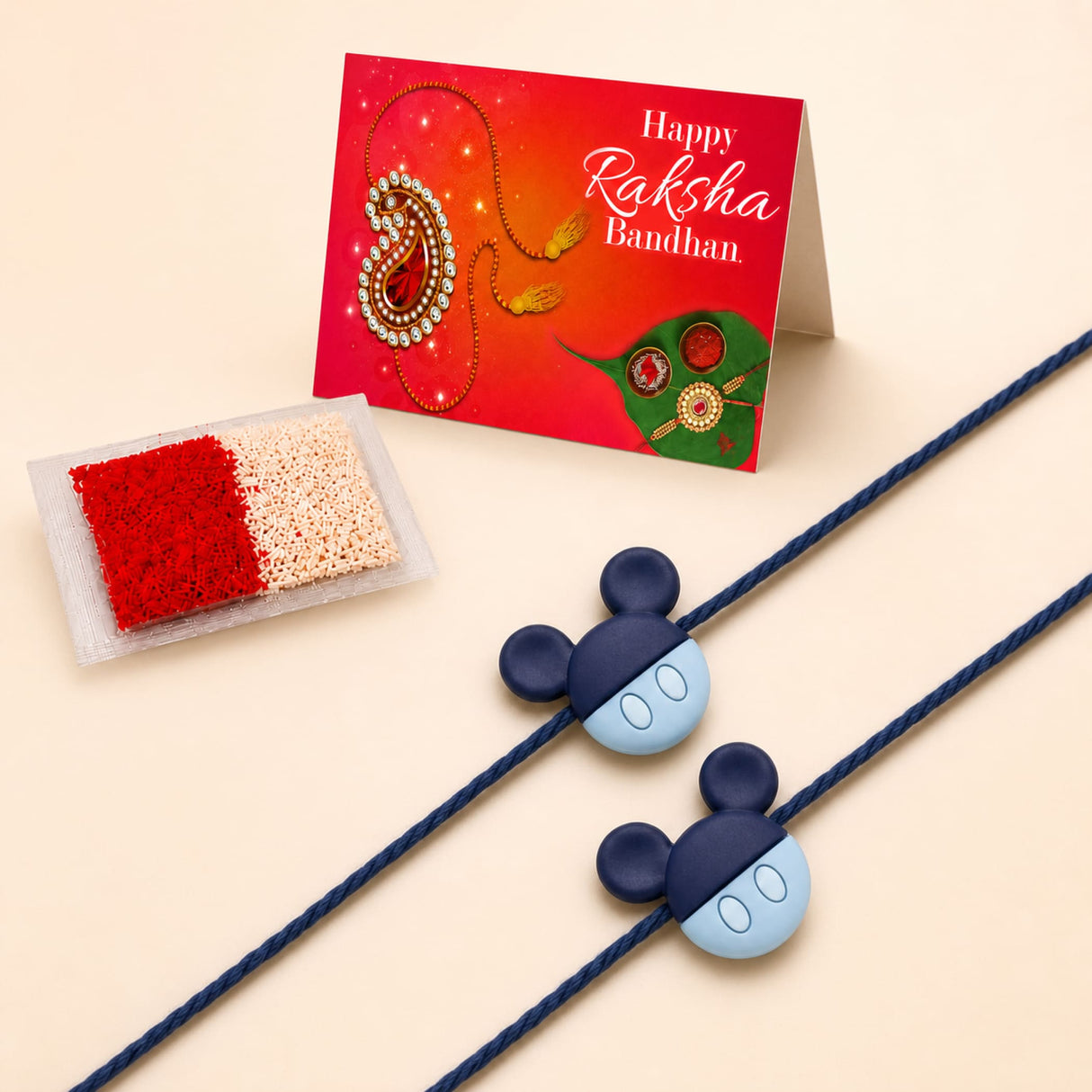 Blue and light blue mickey mouse-themed rakhi with navy blue cord for raksha bandhan gift symbolizing love and protection