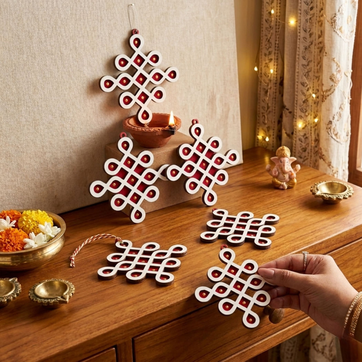 White and red wooden diy small muggu kolam cutout decorations with intricate knot patterns for pooja and wedding decor