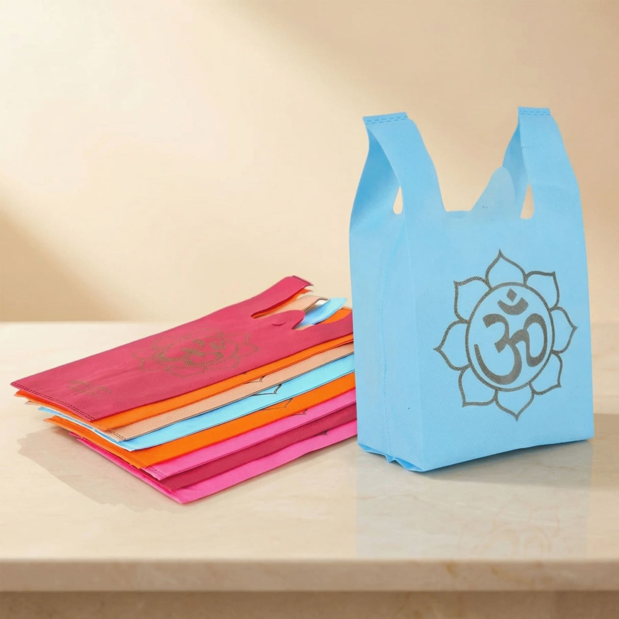 Light blue reusable non woven tote bag with silver om symbol in lotus design for Indian wedding puja favors