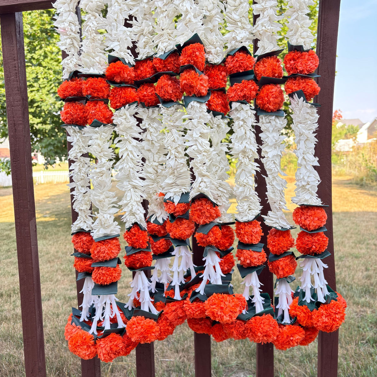 White and orange artificial flower garlands for home decor and festive celebrations