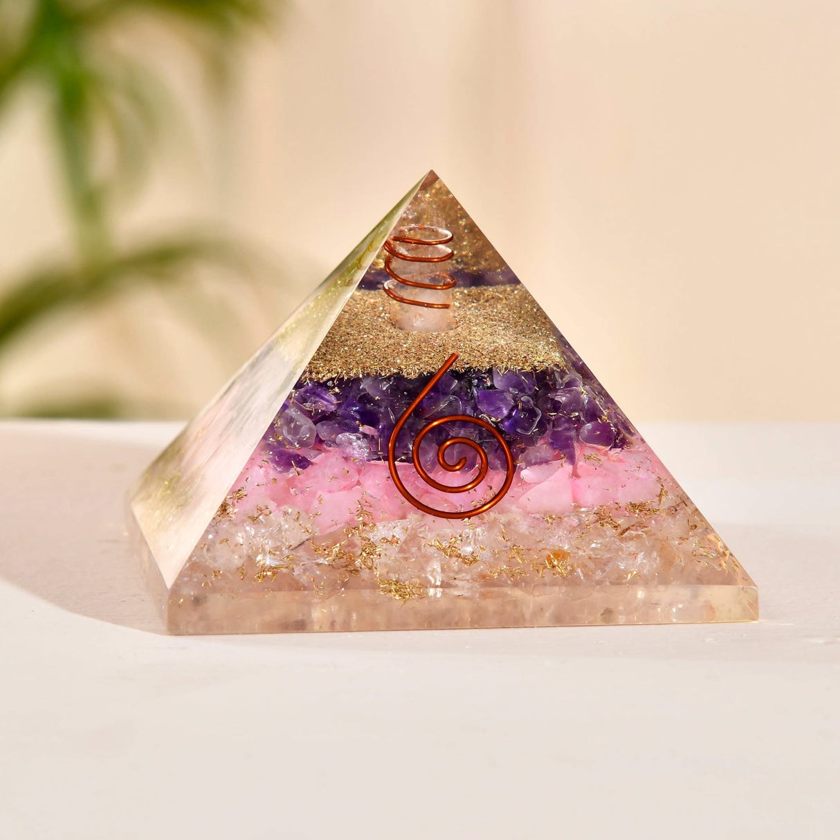 Orgonite pyramid with crystals and copper coils for chakra healing and spiritual energy