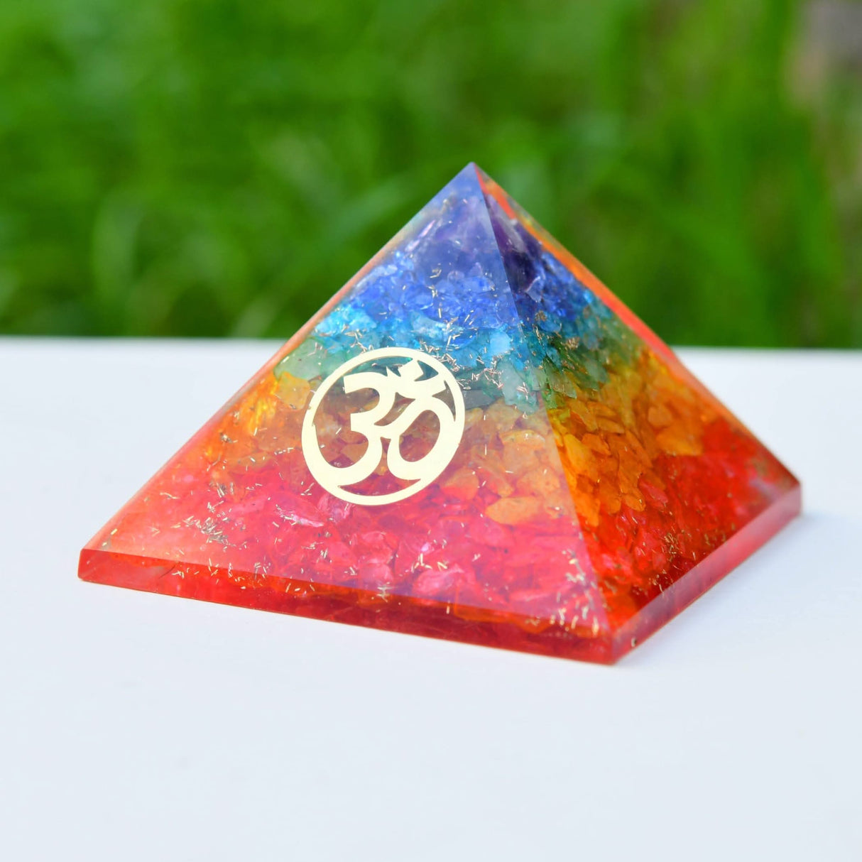 Colorful pyramid with Om symbol representing Chakras for healing and spiritual energy
