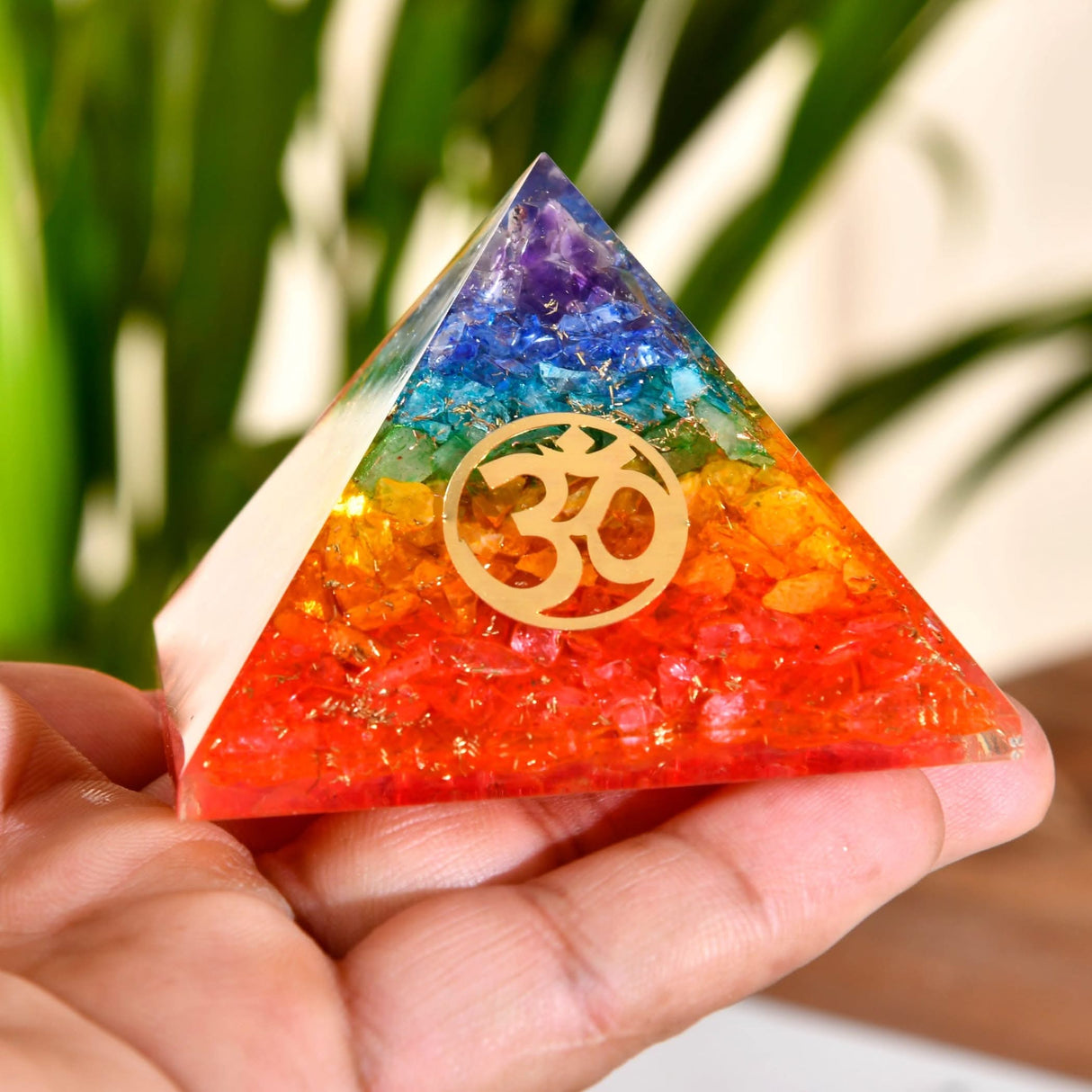 Rainbow-colored orgone pyramid with Om symbol for Chakra healing and spiritual energy